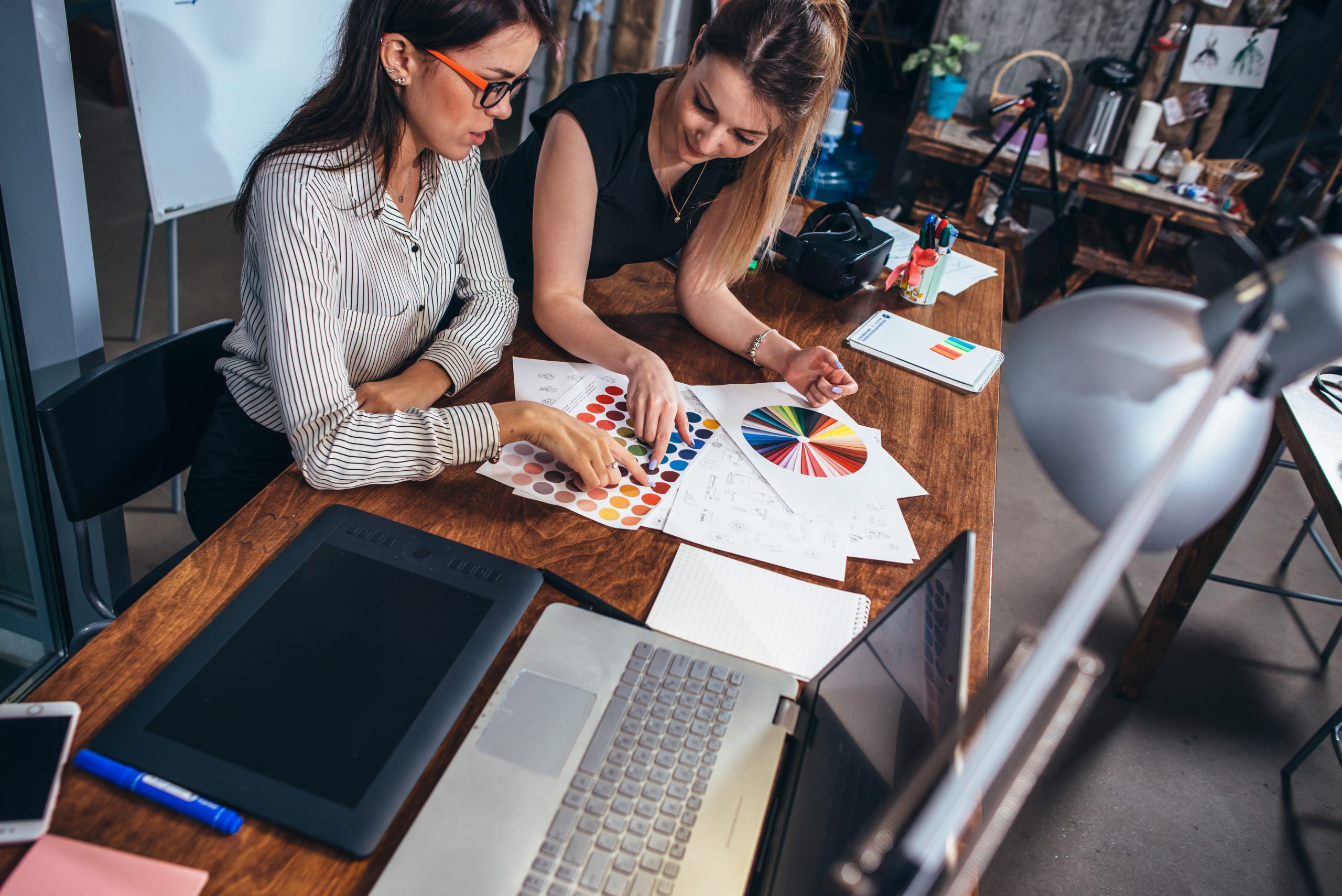 Gusto vs Paychex for payroll, people at table with computers